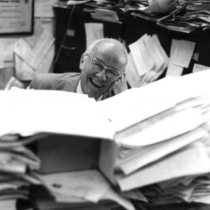 Jovial Magoon surrounded by files